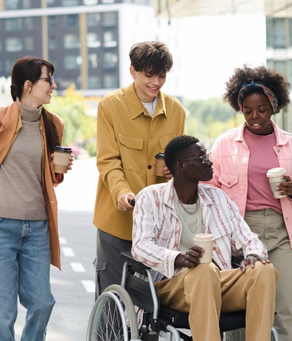 People walking with friend with disability